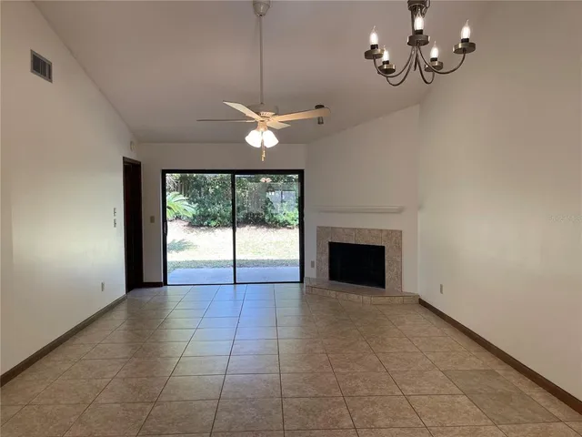a view of a livingroom with a ceiling fan and window