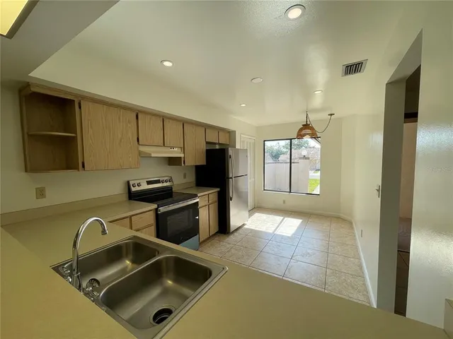 a kitchen with a sink and a refrigerator