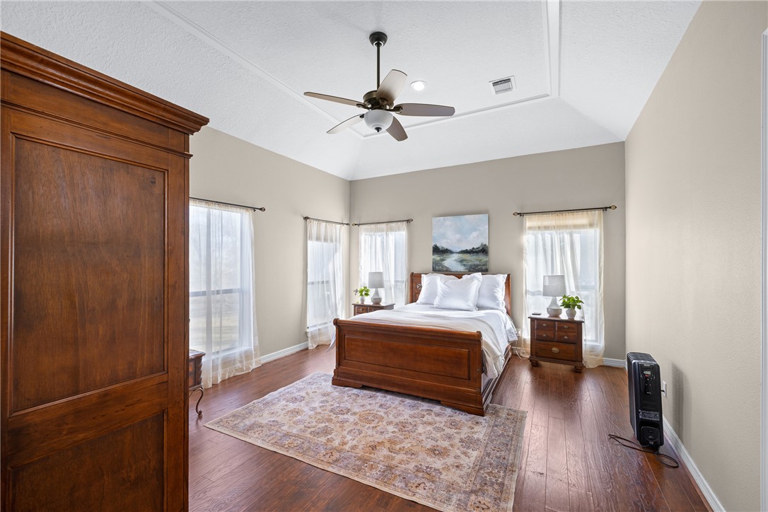 2250 Dillard Road Washington, TX 77880 - Photo 16 of 50 a bedroom with a large bed chandelier and a window