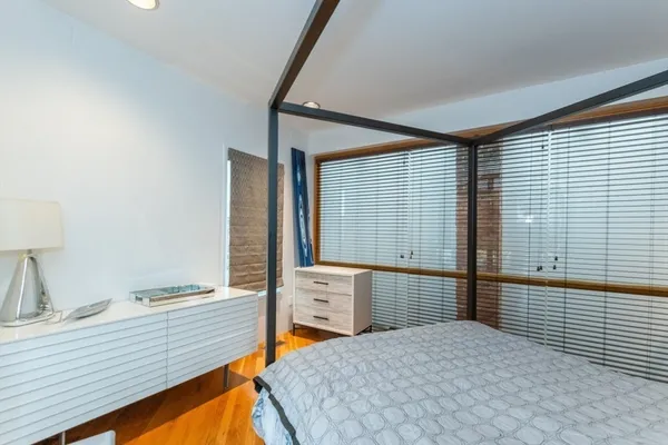 a view of a bedroom with two beds and a window