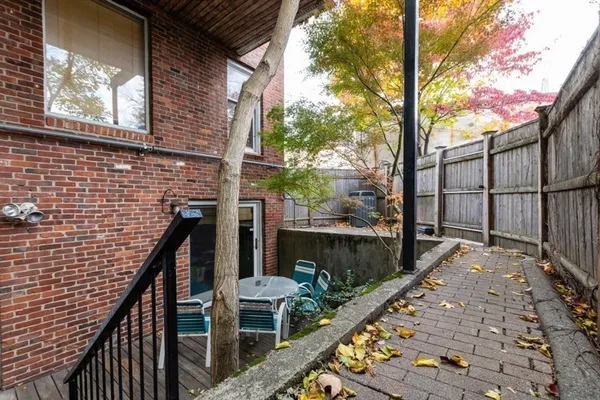 a view of balcony with wooden floor and fence