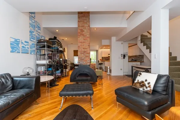 a living room with furniture and a wooden floor