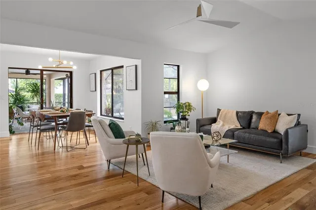 a living room with furniture and wooden floor