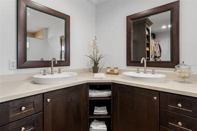 a bathroom with double sink and a mirror