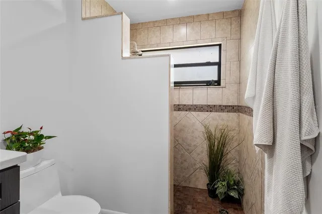 a bathroom with a toilet and a shower curtain