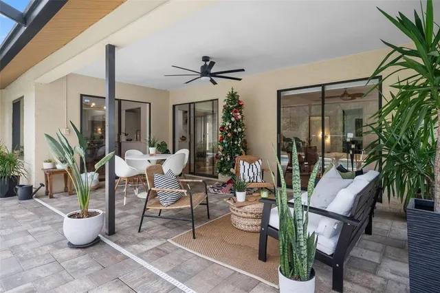 a view of a patio with table and chairs potted plants