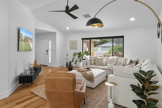 a bedroom with furniture and a large window