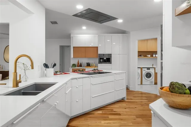 a kitchen with stainless steel appliances granite countertop a sink stove and cabinets