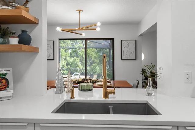 a kitchen with a large window and cabinets