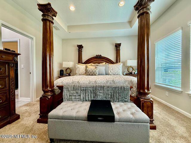 195 Torres Trace St. Augustine, FL 32095 - Photo 12 of 23 a bedroom with a bed and a chandelier