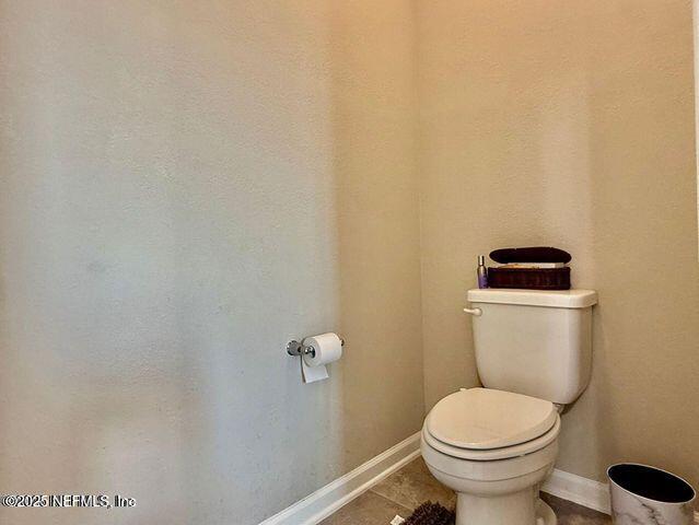 195 Torres Trace St. Augustine, FL 32095 - Photo 18 of 23 a white toilet sitting next to a white sink and vanity