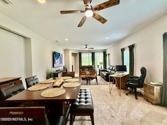 a living room with furniture kitchen view and a window