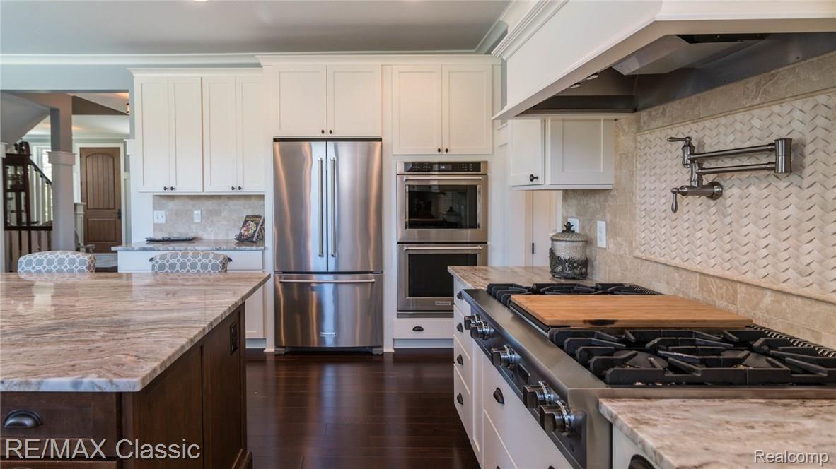 5893 Webster Church Road Dexter, MI 48130 - Photo 8 of 39 Gas Cooktop w/Griddle, 4 Burners, Pot Filler, Hood Fan Venting Outside & Custom Back Splash.