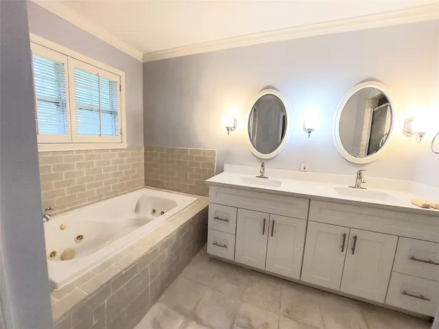 a bathroom with a double vanity sink and a bathtub