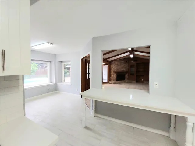 a bedroom with a bed and a view of kitchen