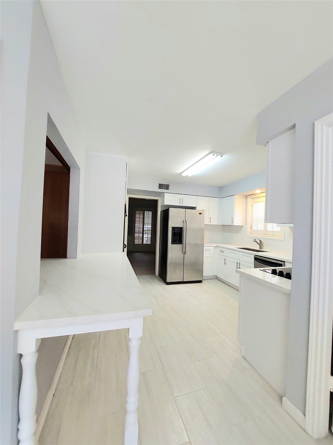 7815 Small Leaf Circle Houston, TX 77063 - Photo 10 of 28 Looking at kitchen from breakfast area, the sliding door leads to the formal dining room