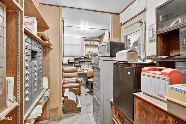 a picture of a living room with furniture and a fireplace