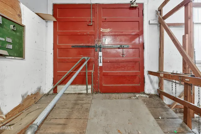 a view of front door with furniture and a window