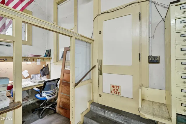 a view of an entryway with wooden floor and a livingroom view