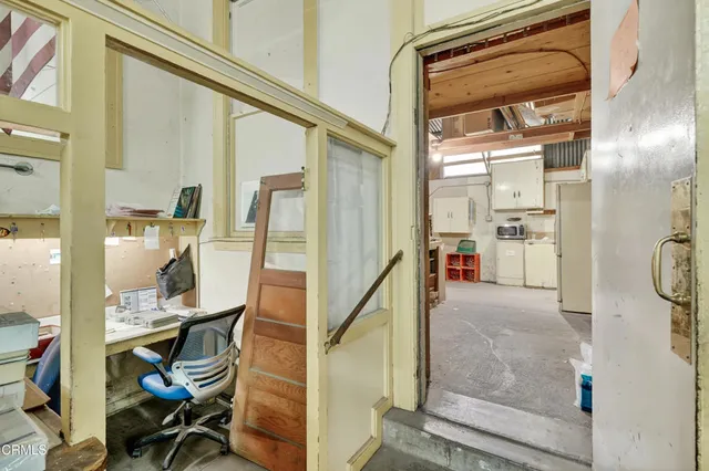 a kitchen with refrigerator and cabinets