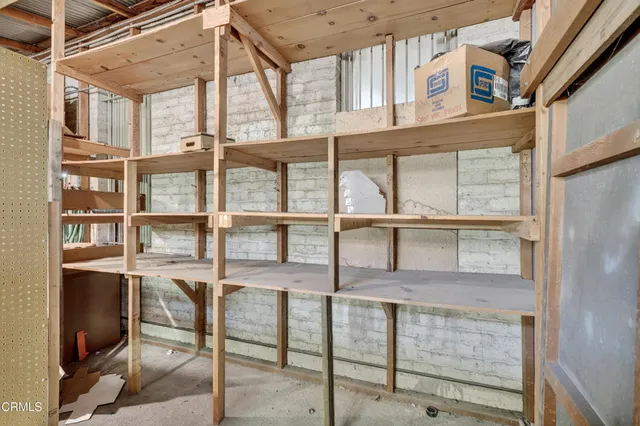 a utility room with dryer washer and racks