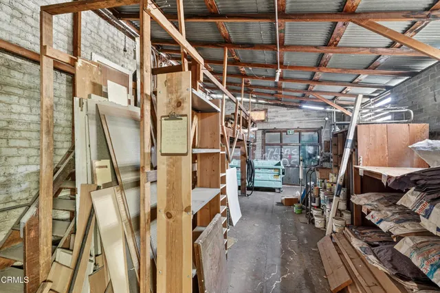 a kitchen with a refrigerator and white cabinets