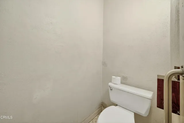 a view of a hallway with wooden walls