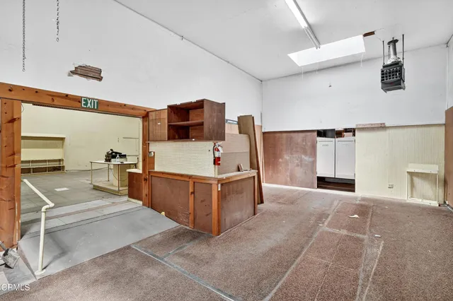 a view of a hallway with wooden cabinets and entryway