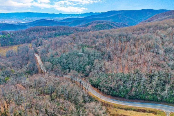 a view of a yard with wooden fence