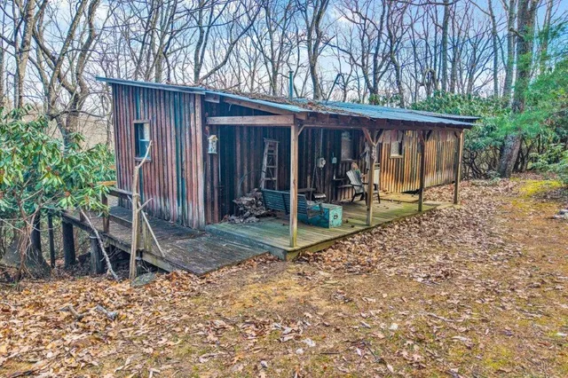 a view of a house with backyard wooden wall and large window