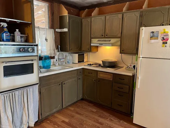 a kitchen with sink a refrigerator and cabinets