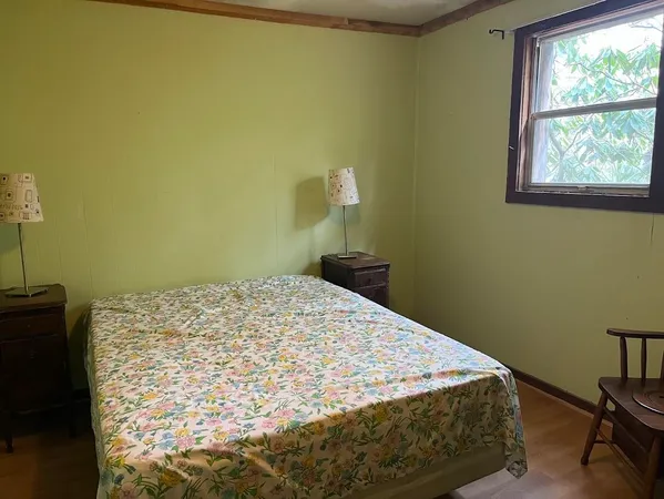 a bedroom with a bed and a window