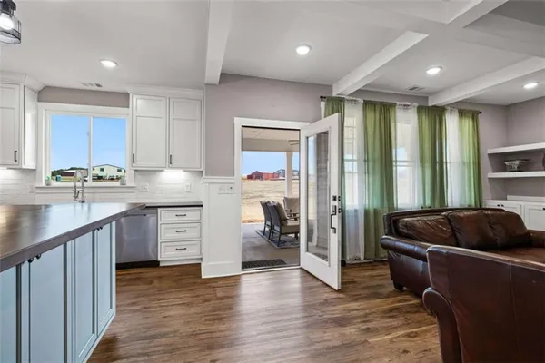 a kitchen with kitchen island granite countertop a sink cabinets and stainless steel appliances