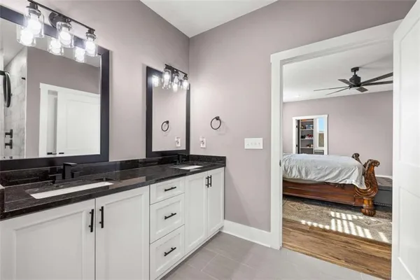 a view of an empty room and window and a ceiling fan