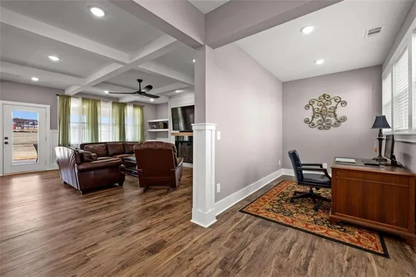 a view of a dining room with furniture wooden floor and a chandelier