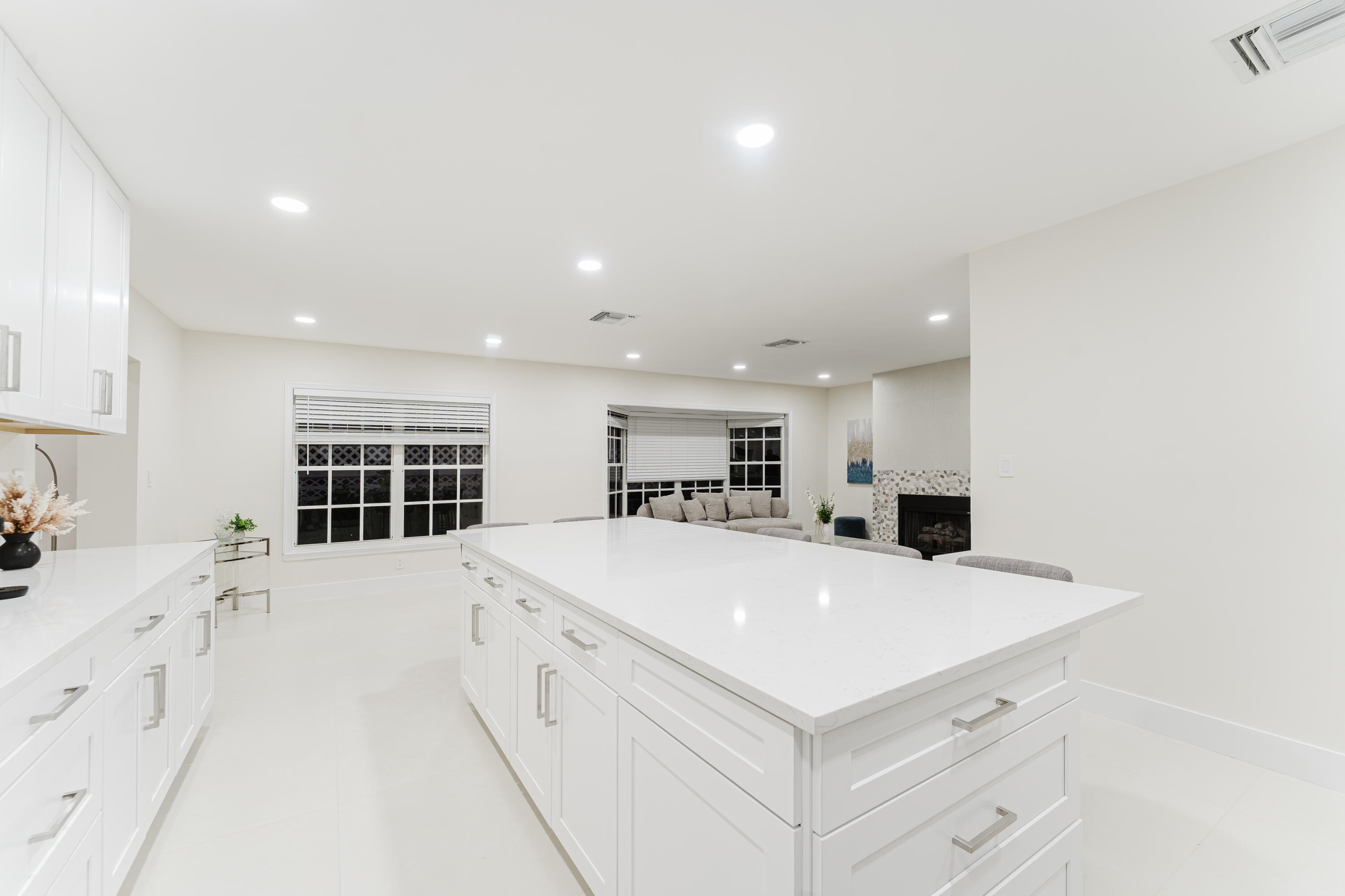 3199 Northeast 6th Drive Boca Raton, FL 33431 - Photo 24 of 49 a large white kitchen with kitchen island a stove a sink a refrigerator and a stove