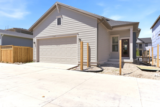 7243 West Terraine Road West Jordan, UT 84081 - Photo 31 of 31 Contemporary single-story residence featuring light-toned horizontal siding, a two-car garage with a paneled door, and a dark asphalt shingle roof