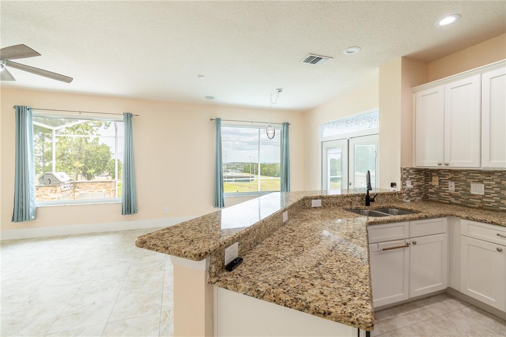 3862 Beacon Ridge Way Clermont, FL 34711 - Photo 28 of 56 a view of a kitchen with a sink stove and cabinets