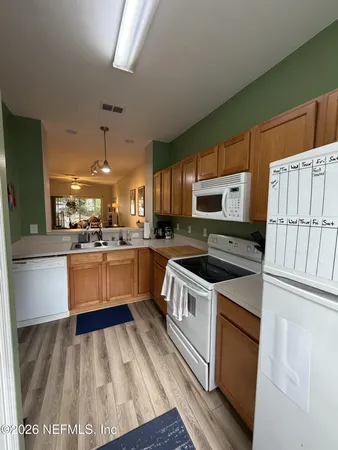 a kitchen with stainless steel appliances granite countertop a stove a sink dishwasher and a refrigerator