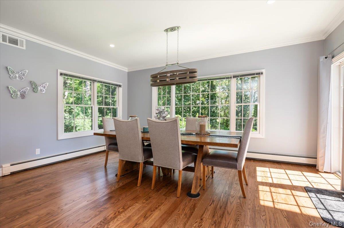 155 Jennings Road Cold Spring Harbor, NY 11724 - Photo 13 of 36 Breakfast area featuring a baseboard heating unit, wood finished floors, ornamental molding, and recessed lighting