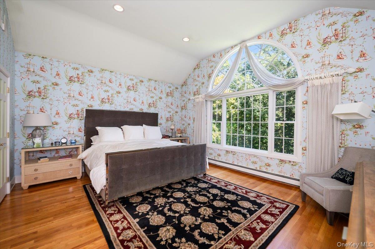 155 Jennings Road Cold Spring Harbor, NY 11724 - Photo 21 of 36 Bedroom with wallpapered walls, lofted ceiling, a baseboard radiator, light wood finished floors, and recessed lighting