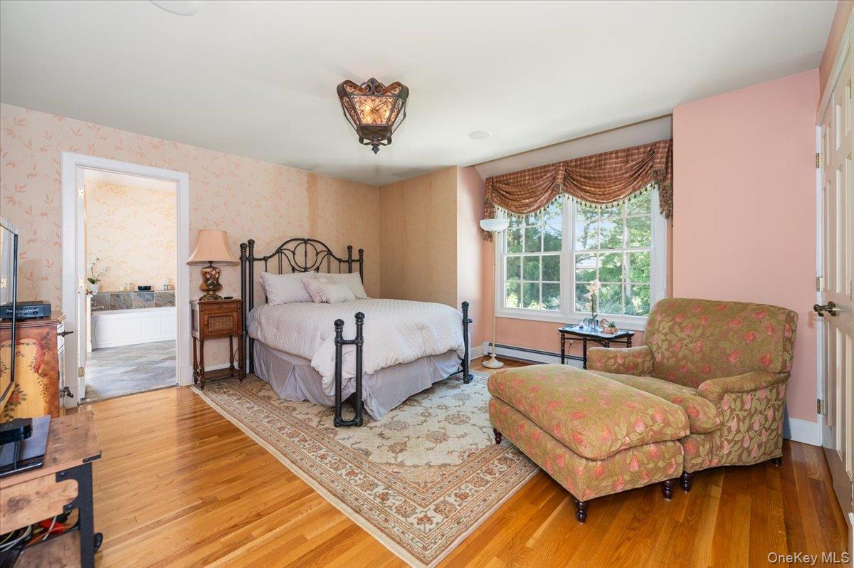 155 Jennings Road Cold Spring Harbor, NY 11724 - Photo 23 of 36 Bedroom featuring wallpapered walls, light wood finished floors, and baseboard heating