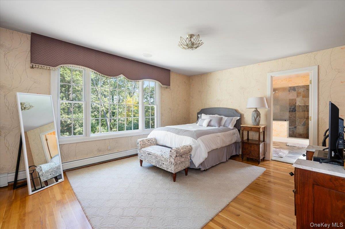 155 Jennings Road Cold Spring Harbor, NY 11724 - Photo 24 of 36 Bedroom with wallpapered walls, light wood-style flooring, and baseboard heating