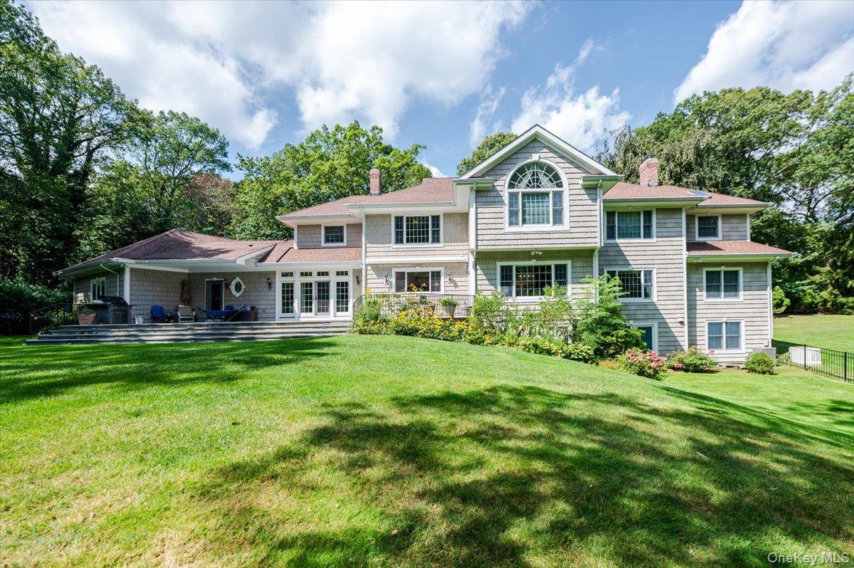155 Jennings Road Cold Spring Harbor, NY 11724 - Photo 3 of 6 a front view of a house with a garden