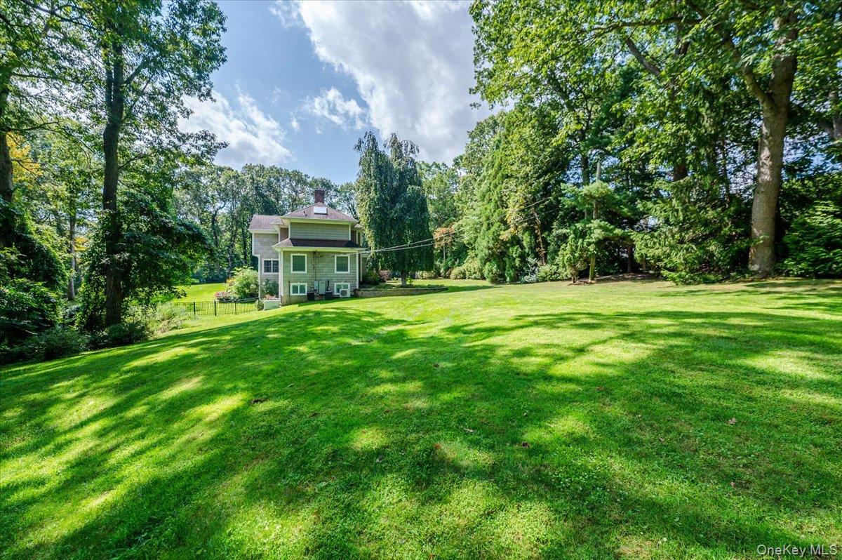 155 Jennings Road Cold Spring Harbor, NY 11724 - Photo 4 of 6 a front view of a house with a big yard