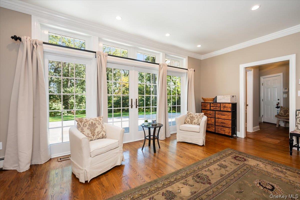 155 Jennings Road Cold Spring Harbor, NY 11724 - Photo 10 of 36 Sitting room with dark wood-style flooring, crown molding, recessed lighting, and french doors