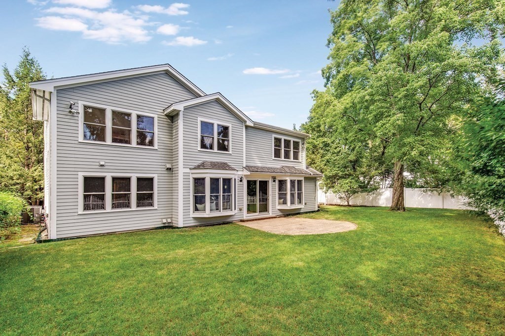 45 Haynes Road Newton, MA 02459 - Photo 11 of 12 a front view of a house with a garden and trees