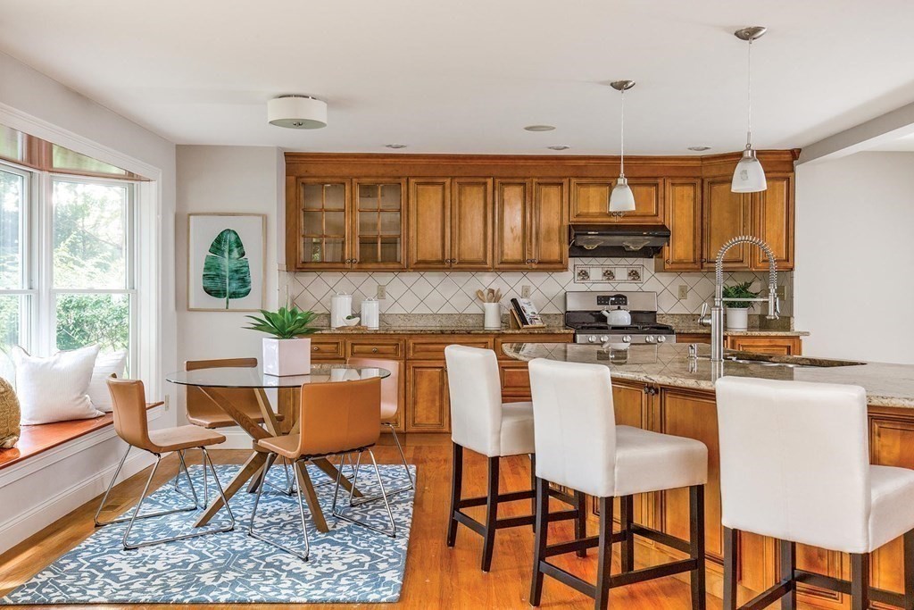 45 Haynes Road Newton, MA 02459 - Photo 5 of 12 a kitchen with stainless steel appliances kitchen island granite countertop a table and chairs in it