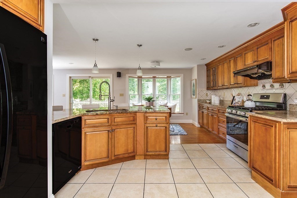 45 Haynes Road Newton, MA 02459 - Photo 6 of 12 a kitchen with stainless steel appliances granite countertop a stove a sink and a refrigerator