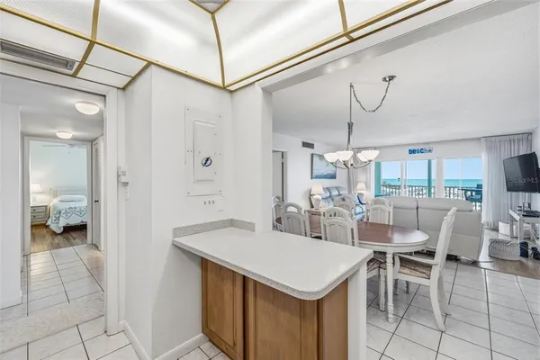 a view of a dining room with furniture and a chandelier